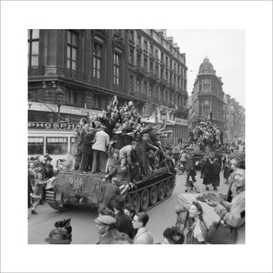 Cheering civilians ride on Cromwell tanks as British troops enter Brussels, 4 September 1944.