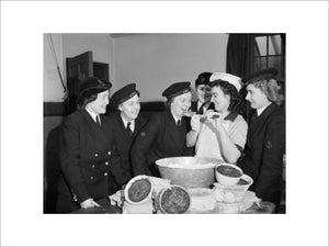 Members of the Women's Royal Naval Service sampling the Christmas pudding at Greenock in Scotland, 19 December 1942.