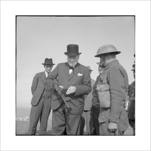 Winston Churchill holds a 'Tommy gun' during an inspection of invasion defences near Hartlepool, 31 July 1940.