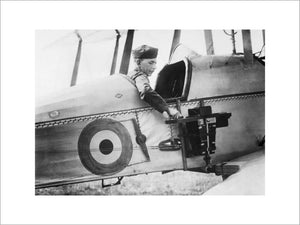 A sergeant of the Royal Flying Corps demonstrates a C type aerial reconnaissance camera fixed to the fuselage of a BE2c aircraft, 1916.