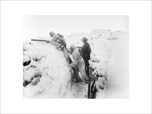 Two men of the 12th East Yorkshires wearing snow suits leaving their snow-covered trench on daylight patrol. Arleux Sector, 9 January 1918.
