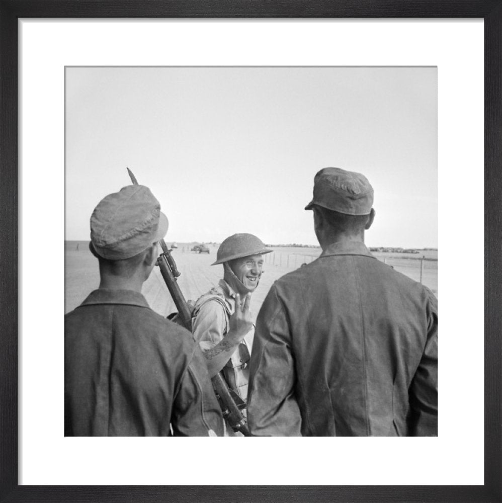 A British Soldier Gives A V for Victory Sign To German Prisoners Captu a-british-soldier-gives-a-v-for-victory-sign-to-german-prisoners-captu