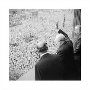 Winston Churchill waves to crowds in Whitehall in London as they celebrate VE Day, 8 May 1945.