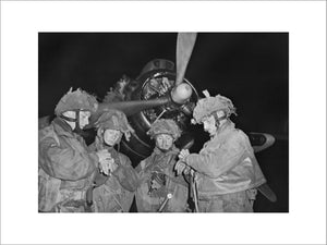 Four 'stick' commanders of 22nd Independent Parachute Company, 6th Airborne Division, synchronising their watches in front of an Armstrong Whitworth Albemarle at about 11 pm on 5 June 1944, just prior to take off from RAF Harwell in Oxfordshire.