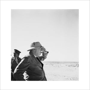 Prime Minister, Mr Winston Churchill wearing sun helmet, viewing the Alamein position.