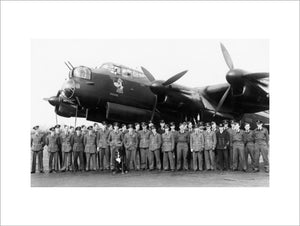 Aircrew of No. 106 Squadron RAF gather in front of the Avro Lancaster flown by the Squadron CO, Wing Commander Guy Gibson (centre, to right of dog), to mark the completion of his first tour of operations, Syerston in Nottinghamshire, March 1943.