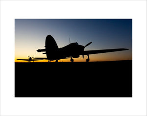 Two Hawker Hurricanes at the Duxford Airfield during sunrise
