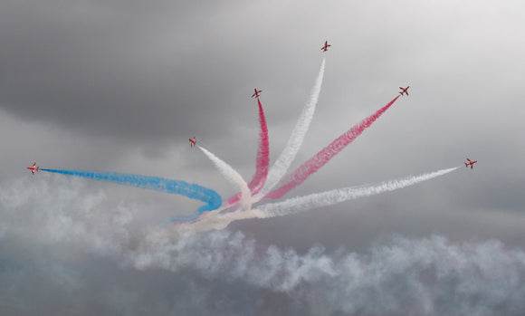The Red Arrows display during a thunderstorm in close proximity to the Duxford Airfield