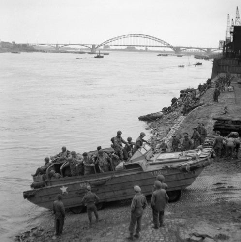 A British DUKW carries supplies and American paratroopers across the Waal river at Nijmegen, 30 September 1944.