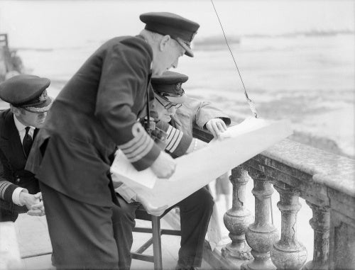 Captain H Hickling, commanding naval forces at Arromanches, shows a plan of the Mulberry artificial harbour to Winston Churchill, July 1944.