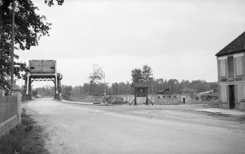 A view of 'Pegasus Bridge' over the Caen Canal at Benouville, 12 July 1944. Two of the Horsa gliders that brought the 'coup de main' force in on the night of D-Day can be seen in the background.