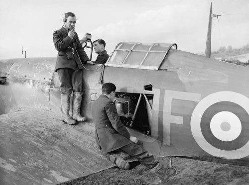 Radio mechanics testing the VHF transmitter/receiver in a Hawker Hurricane Mk I of No. 601 Squadron RAF at Exeter, Devon, November 1940.