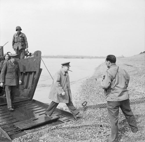 Winston Churchill steps ashore from an American assault landing craft onto the east bank of the River Rhine, near Wesel, 25 March 1945.