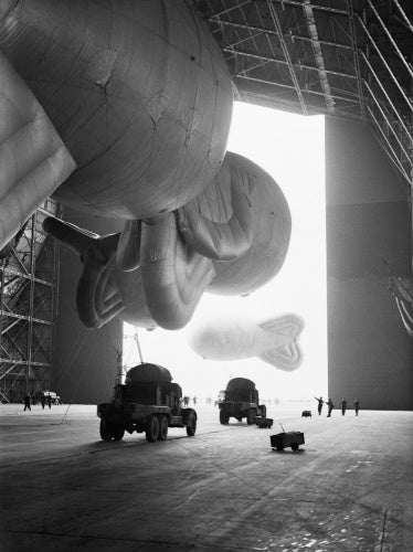 RAF kite balloons are walked out of No. 1 Airship Shed at Cardington for handling practice by No. 1 Balloon Training Unit, October 1940.