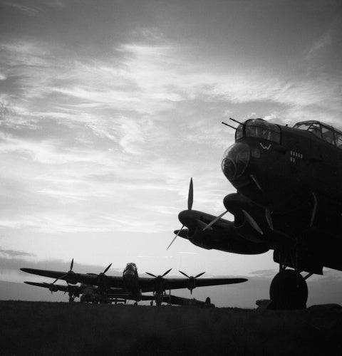 Avro Lancasters of No. 57 Squadron lined up at dusk before an operation, Scampton in Lincolnshire, February 1943.