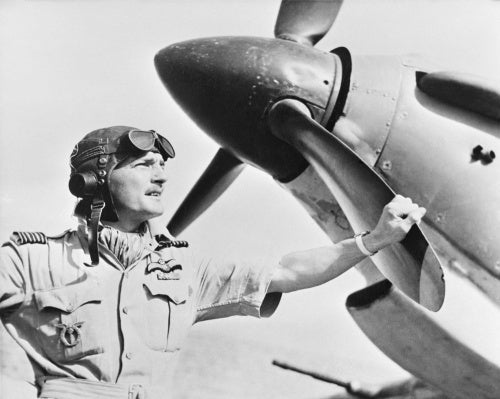 Wing Commander Frank Carey, Officer Commanding the Air Firing Training Unit, based at Amarda Road, India, standing by the nose of a Hawker Hurricane, April 1943.