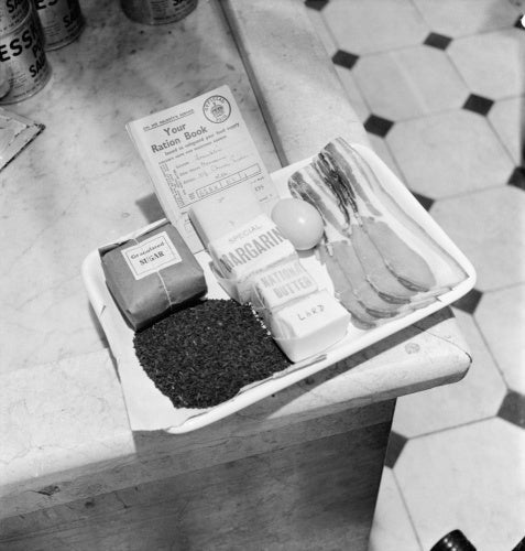 Tray containing a ration book and the weekly ration of sugar, tea, margarine, 'national butter', lard, eggs, bacon and cheese as issued to an adult in Britain during 1942.