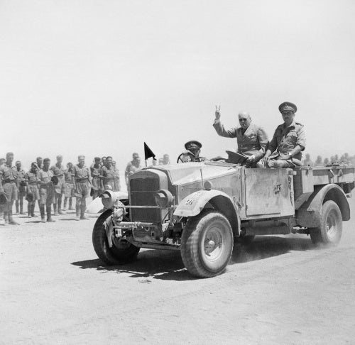 Winston Churchill giving his famous V-for-Victory sign while being driven past a line of troops in Tel-el-Kebir, 9 August 1942.