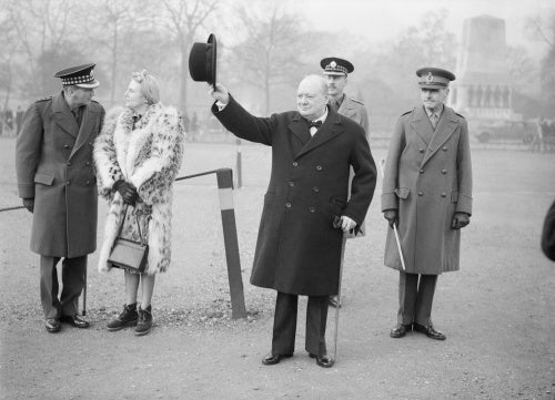 Winston Churchill raises his hat in salute during an inspection of the 1st American Squadron of the Home Guard at Horse Guards Parade in London, 9 January 1941.