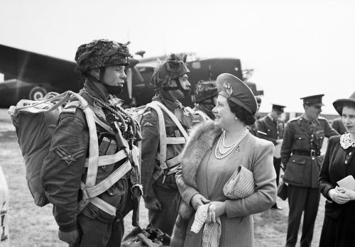 The Queen and Princess Elizabeth talk to paratroopers in front of a Halifax aircraft during a tour of airborne forces preparing for D-Day, 19 May 1944.