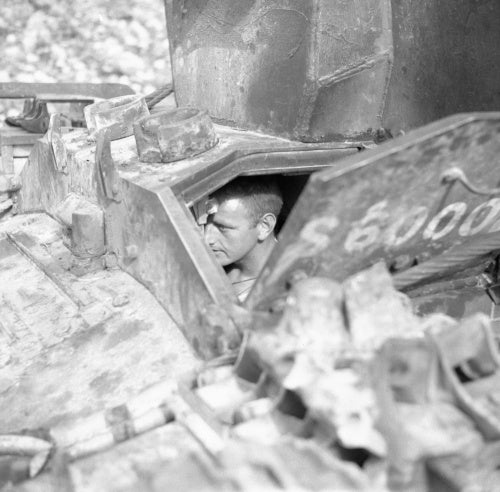 The driver of a Bishop 25-pdr self-propelled gun of 142nd Field Regiment in Sicily, 27 July 1943.