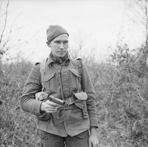 Private W Stack of No. 9 Commando at Anzio, equipped for a patrol with a Browning pistol, 5 March 1944.