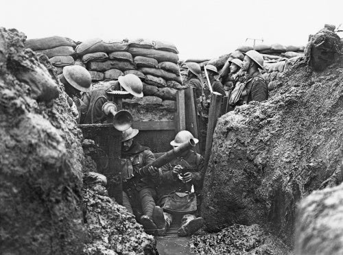 Men of the Lancashire Fusiliers cleaning a Lewis gun in a trench near Messines in Belgium during January 1917.