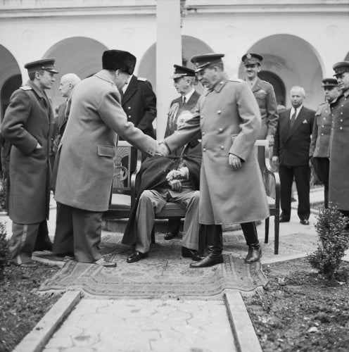 Winston Churchill greets Joseph Stalin with President Roosevelt outside the Livadia Palace during the Yalta Conference, February 1945.