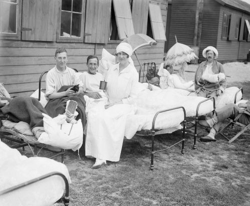 The Duchess of Sutherland sitting with patients at her hospital at Calais during July 1917.