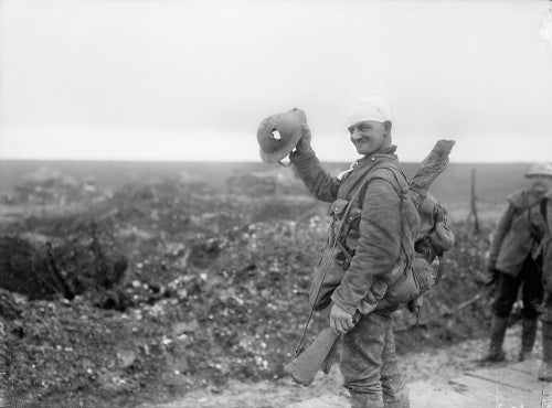 Wounded British soldier showing shrapnel damage to his steel helmet caused near Hamel on the Somme Front in December 1916.