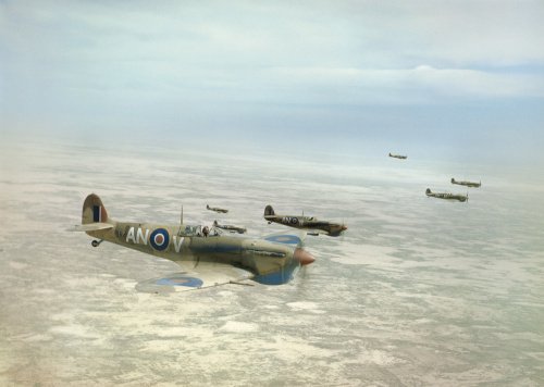 Supermarine Spitfire Mk Vbs of No. 417 Squadron, Royal Canadian Air Force, flying in loose formation over the Tunisian desert on a bomber escort operation, April 1943.
