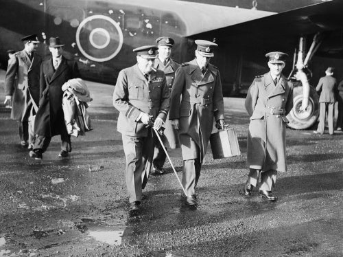 The Prime Minister, Winston Churchill in RAF uniform, accompanied by Air Chief Marshal Sir Charles Portal, Chief of the Air Staff, leaving Consolidated Liberator 