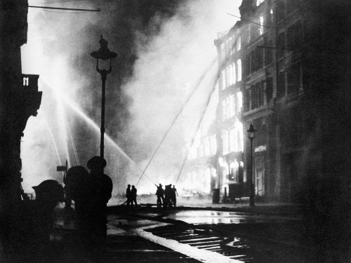 Members of the London Fire Brigade train their hoses on burning buildings in Queen Victoria Street, EC4, after the last and heaviest major raid mounted on the capital during the 'Blitz'.