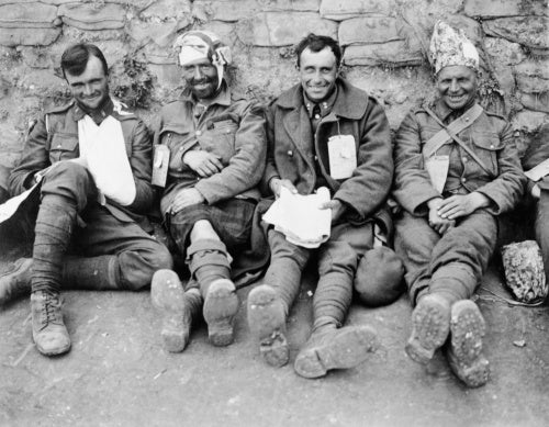A portrait of four smiling Canadians, as they await treatment at a Casualty Clearing Station, Duisans, 3 September 1918.