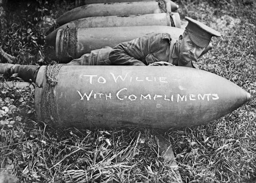 Gunner of the Royal Marine Artillery posing with shell near Acheux, Somme, July 1916.