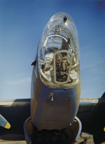A Flight Lieutenant bomb-aimer of No 223 Squadron, Royal Air Force checks over his bomb sight