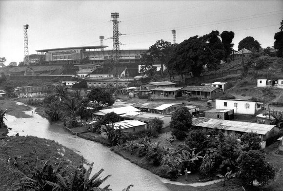 Siaka Stevens Stadium, Sierra Leone's national stadium, became home to thousands of people displaced by the Civil War (1991 - 2002), many of whom continued to live in the stadium after the fighting had ended. Photographed by Tim Hetherington.