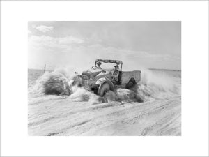 A British Army 15-cwt truck throws up a cloud of sand and dust while moving at speed along a desert track in North Africa, 1 November 1940.