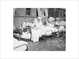 The Duchess of Sutherland sitting with patients at her hospital at Calais during July 1917.