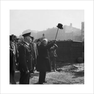 Winston Churchill holds his hat aloft to acknowledge cheers from workers at a Manchester factory, April 1941.