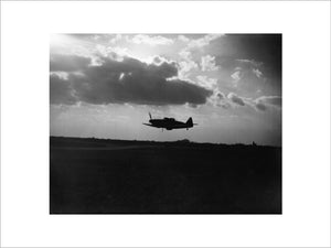 Boulton Paul Defiant Mk I night-fighter of No. 264 Squadron RAF, silhouetted against the clouds during a low-level pass over its base at Biggin Hill, Kent, April 1941.