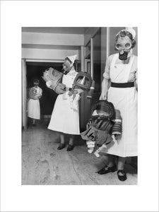 Nurses carry babies during a gas drill in a London hospital during 1940.