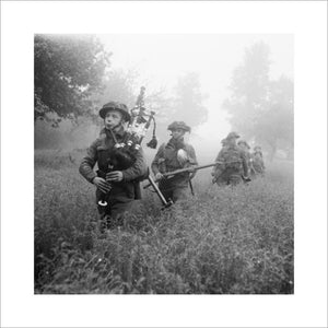 Led by their piper, men of 7th Seaforth Highlanders, 15th (Scottish) Division advance during Operation 'Epsom' in Normandy, 26 June 1944.