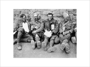 A portrait of four smiling Canadians, as they await treatment at a Casualty Clearing Station, Duisans, 3 September 1918.
