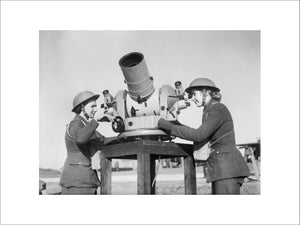 Two members of the Auxiliary Territorial Service (ATS) check the accuracy of anti-aircraft fire from a gun battery during the Second World War.