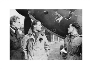 Squadron Leader Douglas Bader (centre) and fellow pilots of No. 242 Squadron, Flight Lieutenant Eric Ball and Pilot Officer Willie McKnight, admire the nose art on Bader's Hawker Hurricane at Duxford, October 1940.
