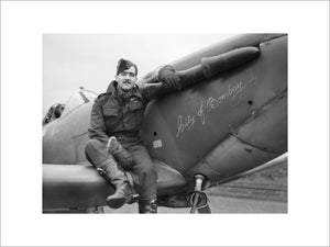 Squadron Leader H J L Hallowes, CO of No. 122 Squadron, with his Supermarine Spitfire Mk V at Scorton in Yorkshire, December 1941.