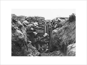 Men of the Lancashire Fusiliers cleaning a Lewis gun in a trench near Messines in Belgium during January 1917.