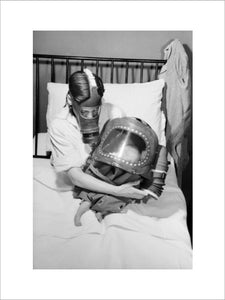 A mother and baby both in gas-masks during 1941.