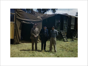 Winston Churchill flanked by the Chief of the Imperial General Staff, Field Marshal Sir Alan Brooke and General Sir Bernard Montgomery, commanding 21st Army Group, at Monty's mobile headquarters in Normandy, 12 June 1944.